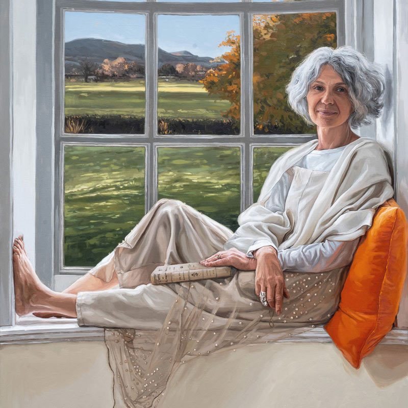 MS Oil painting of a Stylish woman with grey hair sitting on a windowsill, smiling, with a book on her lap and a Yorkshire view behind her.